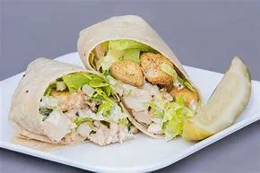 Grilled Chicken Caesar Wrap $15.95 With grilled chicken, Romaine lettuce and grated cheese, in our Caesar dressing, served with French fries. Grilled